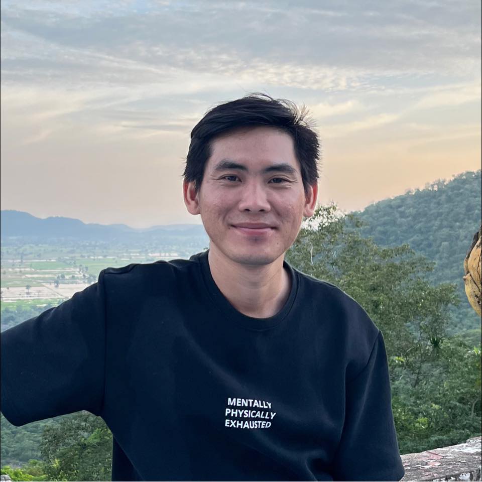 Rathkalyforgna Chhin smiling in a black shirt